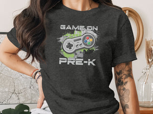 Dark grey t-shirt with a video game controller graphic and text "GAME ON PRE-K".