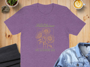 Purple t-shirt with sunflowers and text "Be the Sunshine ON A CLOUDY DAY."