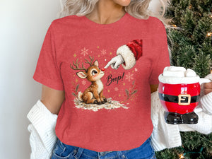 Christmas graphic t-shirt with a reindeer, Santa's hand, and "Boop!" text.