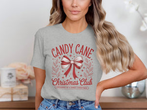 Grey t-shirt with red "Candy Cane Christmas Club" text and bow graphic.