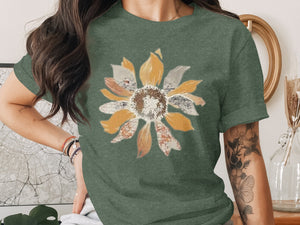 Green t-shirt with a collage-style sunflower graphic on the front.
