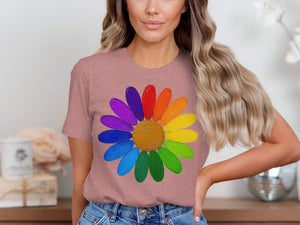 Pink t-shirt with a rainbow daisy graphic printed on the chest.