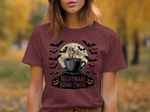 Maroon t-shirt with Halloween design: coffee cup, moon, bats, and pumpkins. "Nightmare Before Coffee" text.