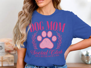 Blue t-shirt with distressed pink graphic: "Dog Mom Social Club Life Is Better With A Dog".