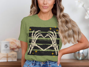 Green t-shirt with skeleton hands forming a heart on a striped background with yellow stars.