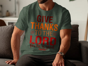Green t-shirt with red and orange text reading "GIVE THANKS TO THE LORD for he is good PSALM 107:1".