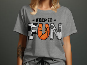 Grey t-shirt with text "KEEP IT FUN" featuring a soccer ball, basketball, and video game controller.