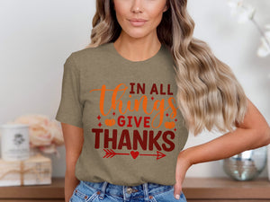 T-shirt with "In All Things Give Thanks" text, pumpkins, and arrows.