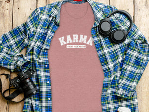Pink t-shirt with "Karma Coming Back Around" graphic, plaid shirt, headphones, and camera.