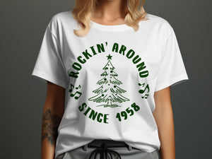 White t-shirt with green "Rockin' Around Since 1958" text and Christmas tree design.