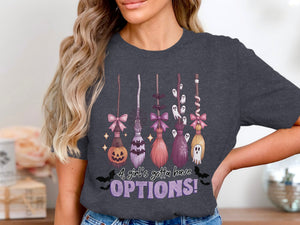 Halloween graphic tee with brooms, pumpkin, bats, ghosts, and text.