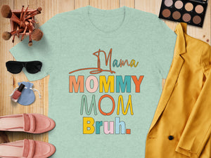 Light teal t-shirt with "Mama Mommy Mom Bruh" text in colorful retro font.