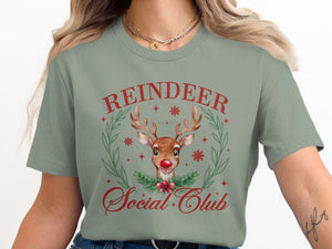 Green t-shirt with red text "Reindeer Social Club" and watercolor reindeer graphic.