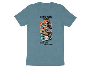 T-shirt with stacked vintage game controllers and text "LET'S PLAY NOW!"