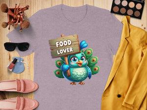 Purple t-shirt with cartoon peacock holding a "Food Lover" sign.