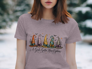 T-shirt with watercolor witch hats and bats, reads "A Girls Gotta Have Options."