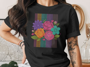 Black t-shirt with a colorful floral bouquet design against a striped background.