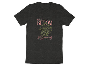 Dark grey t-shirt with "WE ALL BLOOM Differently" text and floral design.
