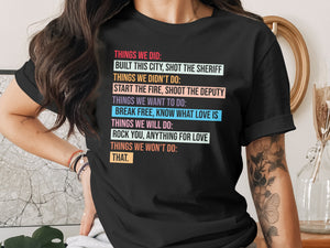 Black t-shirt with colorful text listing "Things We Did" and "Things We Didn't Do."