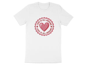 White t-shirt with a red circular graphic containing a polka dot heart and the text "Love is All Around."