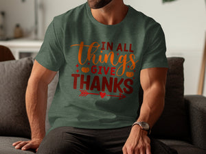 Dark green t-shirt with "In All Things Give Thanks" text and pumpkins.