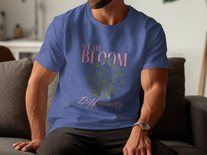 Blue t-shirt with "We All Bloom Differently" text and floral design.