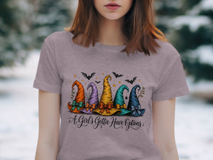 T-shirt graphic with five colorful witch hats and the text "A Girl's Gotta Have Options."