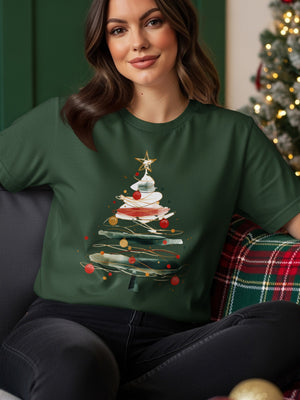 Woman wearing a green t-shirt with an abstract watercolor Christmas tree design.