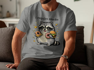 Grey t-shirt with raccoon graphic and text "i require snacks"
