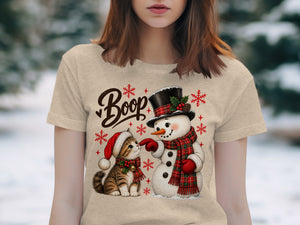 T-shirt graphic with cat and snowman saying "Boop" surrounded by snowflakes.