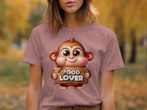 Cartoon monkey holding a "FOOD LOVER" sign on a pink t-shirt.