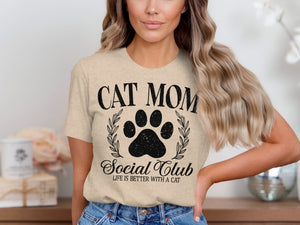 "Cat Mom Social Club" graphic t-shirt with paw print and laurel wreath.