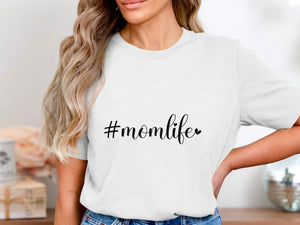 White t-shirt with black "#momlife" text and a small heart.