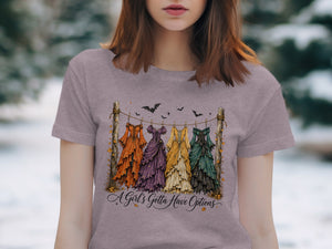 Four colorful, layered dresses hang on a clothesline with bats overhead and text below.