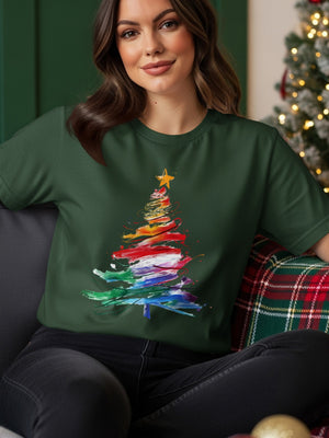 Dark green t-shirt with a rainbow watercolor Christmas tree and yellow star graphic.