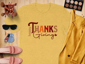 Yellow t-shirt with "Happy Thanksgiving" text, surrounded by makeup and clothing.