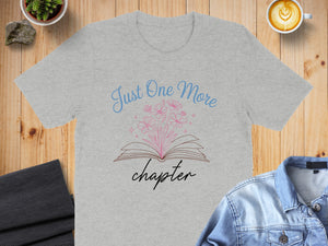 Grey t-shirt with "Just One More Chapter" book and flower graphic.