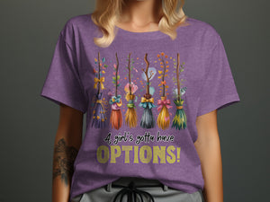 Purple t-shirt with a line of decorative brooms and the text "A girl's gotta have OPTIONS!"