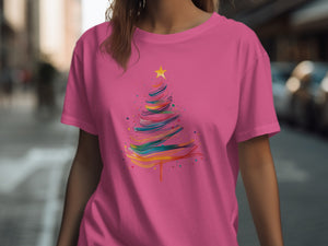 Pink t-shirt with colorful abstract Christmas tree and star graphic.