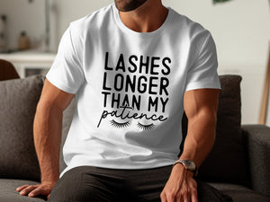 White t-shirt with black text reading "Lashes Longer Than My Patience" and an illustration of eyelashes.