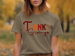 Brown t-shirt with "Happy Thanksgiving" graphic in varying warm colors.