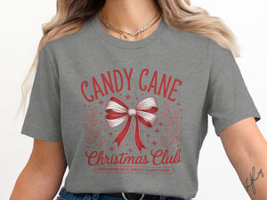 Grey t-shirt with "Candy Cane Christmas Club" text and bow graphic.