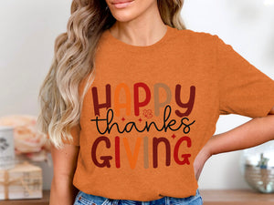 Orange t-shirt with "Happy Thanksgiving" text and a small leaf graphic.