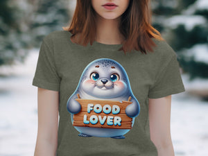 Cute seal graphic on a t-shirt holding a wooden sign that reads "FOOD LOVER."