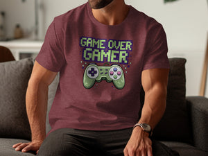 Maroon t-shirt with green pixelated "GAME OVER GAMER" text and a green gamepad.