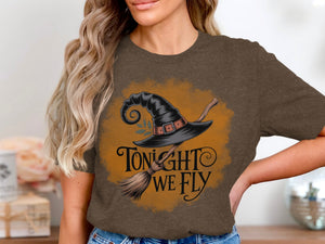 Brown t-shirt with witch's hat and broom design that says "Tonight We Fly".