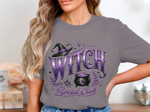 Gray t-shirt with purple "Witch Social Club" text, cauldron, and witch hat graphic.