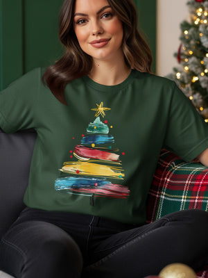 Green t-shirt with a colorful, abstract Christmas tree graphic and star.