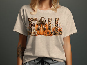 Light tan t-shirt with leopard print "FALL" text featuring a pumpkin and autumn flowers.