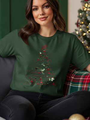 Green t-shirt with a watercolor Christmas tree design featuring red ornaments and holly.